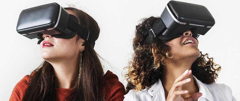 Two women experiencing virtual reality goggles