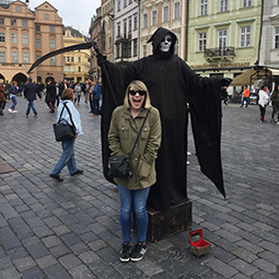 girl standing in front of the grim reaper