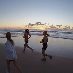 girls jogging on the beach