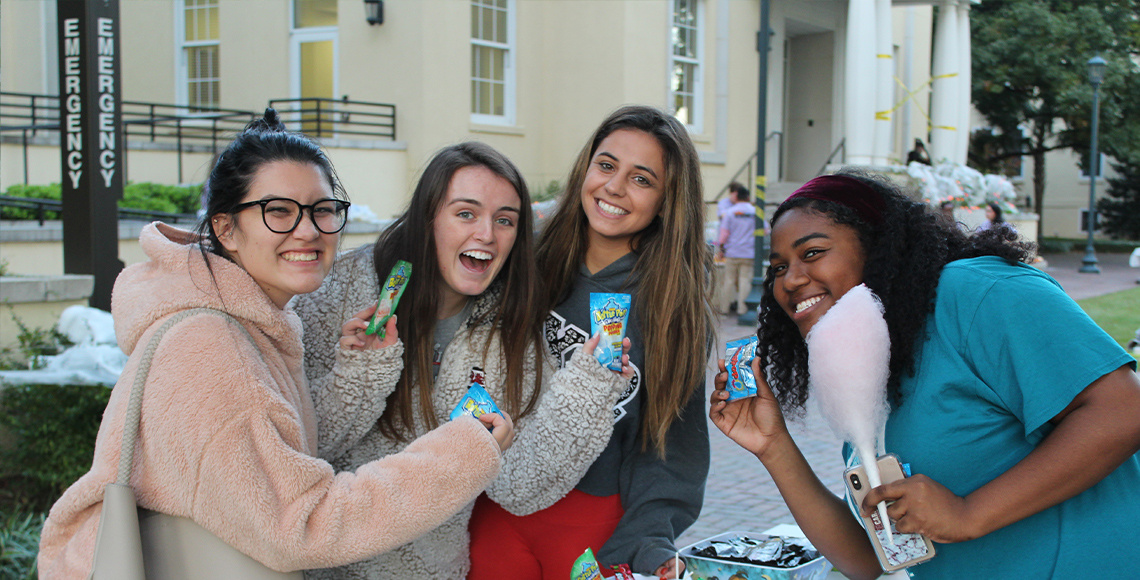Picture of students holding candy at outdoor event