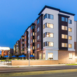 At night, the Park Place residence hall is highlighted with night street lighting and apartments rooms lit up.