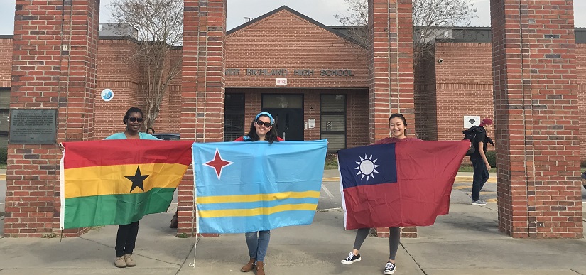 Photo of international students showing their country flags 