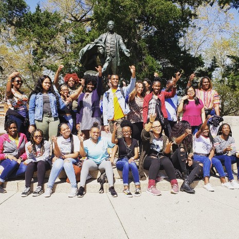Students gathered at Tuskegee University Booker T Washington statue.