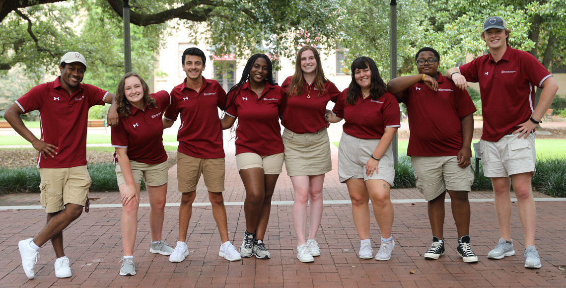 Orientation Leaders smiling outside and posing for a picture outside of the McKissick Museum
