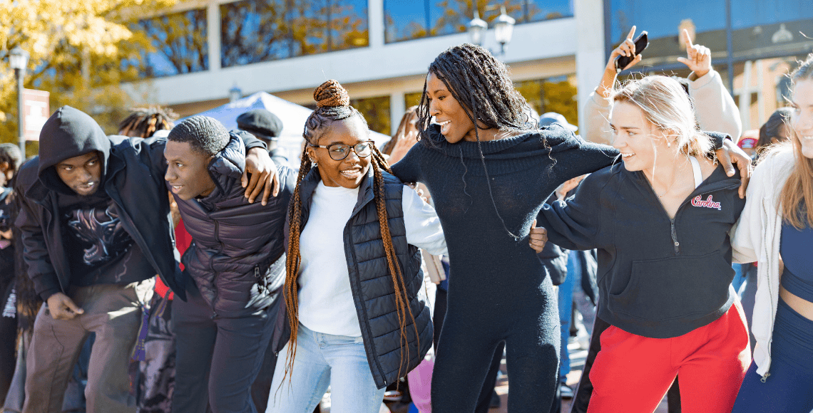group of USC students locked arms outside the Russell House
