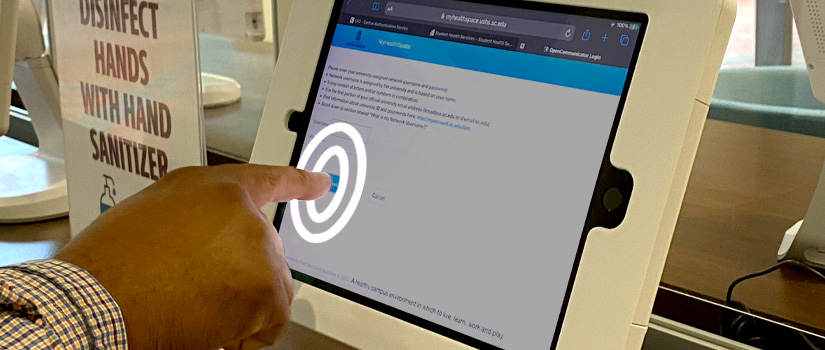 Person touches MyHealthSpace login screen