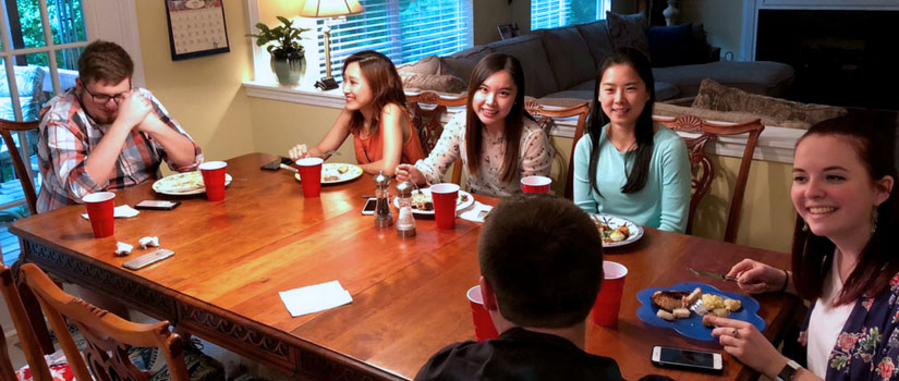 students having dinner at their instructor's home
