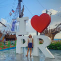 Girl standing in front of a I heart Puerto Rico sign.