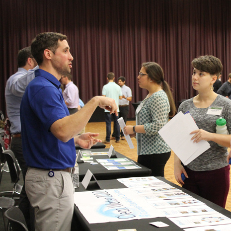 students speaking with an employer at the green career fair