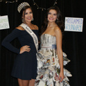 Miss South Carolina posing with a student model who is wearing a dress made out of newspaper