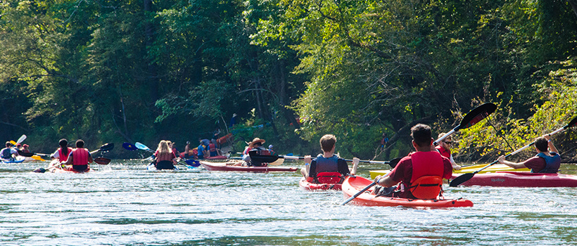 Students kayaking on the river.