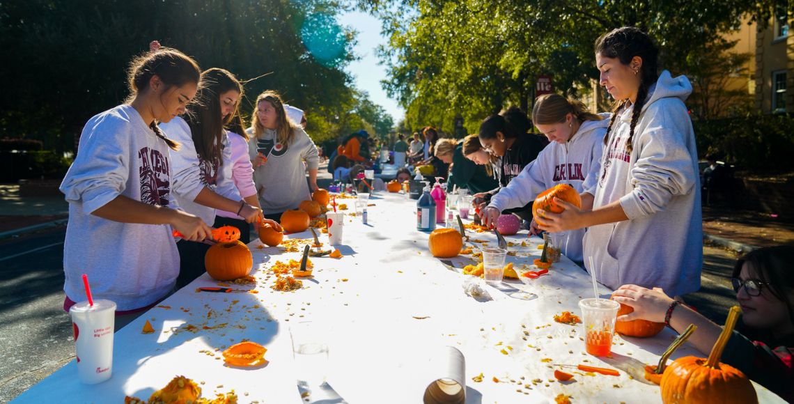 Students carving pumpkin