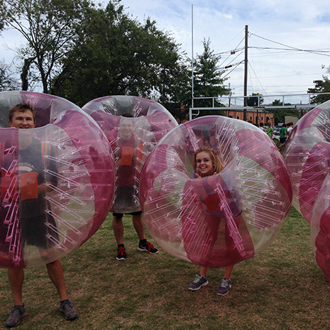 Students in inflateable bubbles at a top scholar event