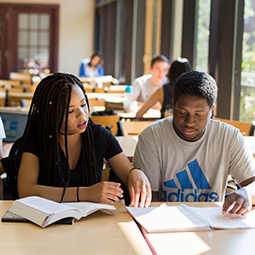Students studying together at a table at Russell House.