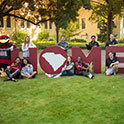 group of students posing in front of HOME letters