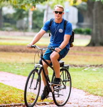 Boy biking on campus