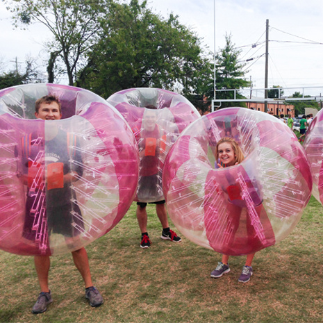 Students in inflateable bubbles at a top scholar event