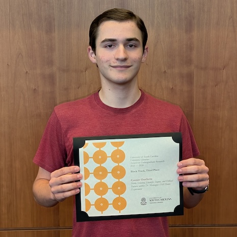 Conner Ouellette holding his award