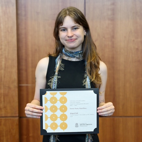 Abigail Still holding her award