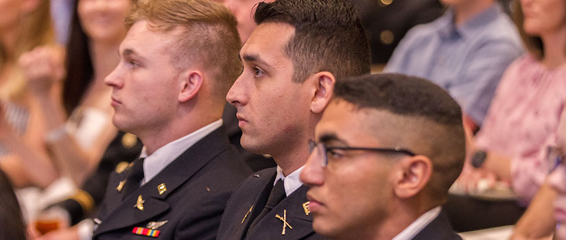 students in uniform listen intently to a presentation
