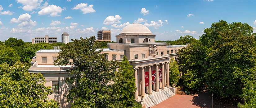 Areal view of McKissick Museum surrounded by the historic trees of the horseshoe and Capstone House and buildings in the background. 