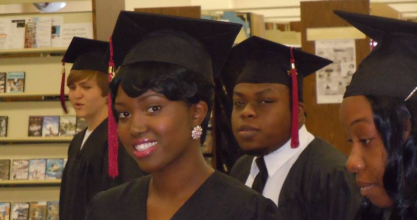 Graduates wait for commencement in the library.