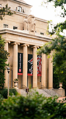 McKissic Museum sits at the top of the Historic Horseshoe with large columns and University of South Carolina banners.