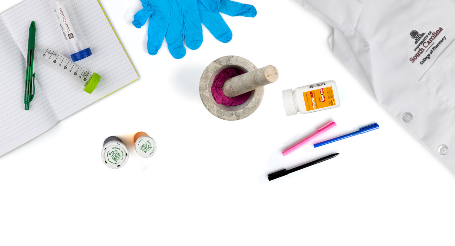 Various items related to the School of Pharmacy displayed on a white background. 
