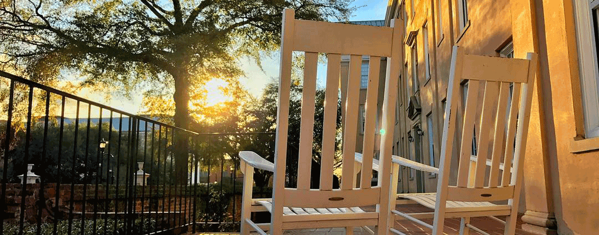 sunrise on campus with rocking chairs