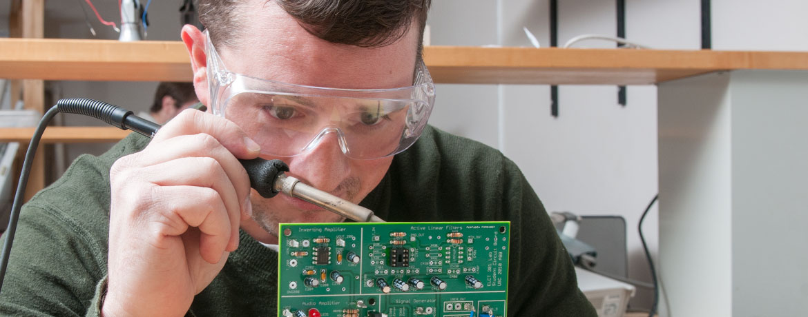 student soldering a circuit board