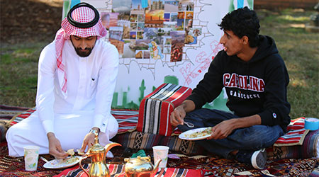 Two students eating at an international student event. 