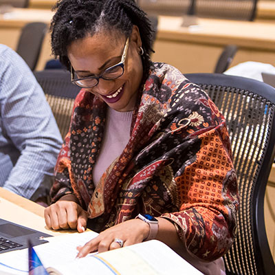Student looking at a book in a classroom.