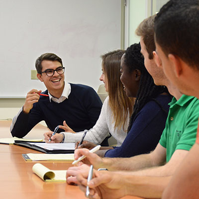 Students talking togehter at a table.