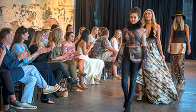 Models walk the runway at a fashion show.