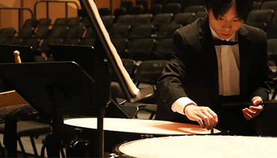 Percussion player in a tux on stage.
