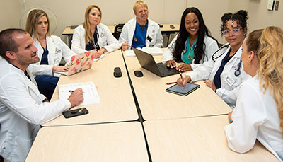 Group of medical professionals in a meeting at a conference table.