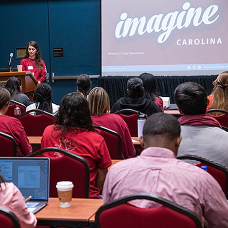 a group of students listen to a speaker at Imagine Carolina