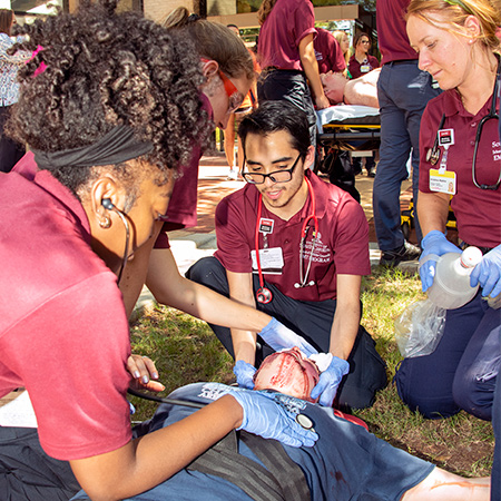 Medical students assisting a patient in an emergency training course.