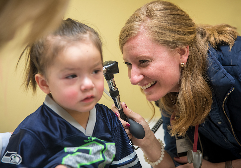 Doctor looking into a child's ear. 