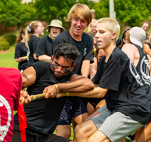Students pulling together in a tug-o-war game.