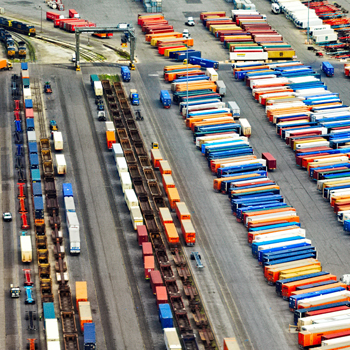 a large group of colorful shipping containers in stacks