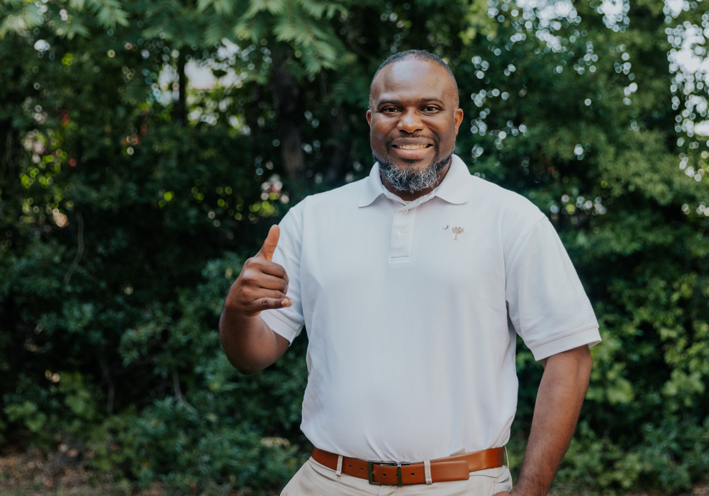 Keron Hopkins poses displaying the spurs up hand signal.