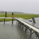 Two scientists on research pier in rain