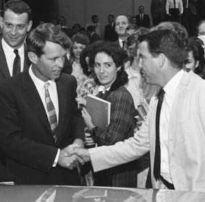 Image of Robert Kennedy shaking hands with others