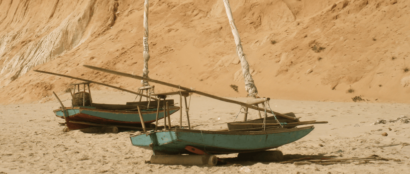 Two old sailboats on a beach