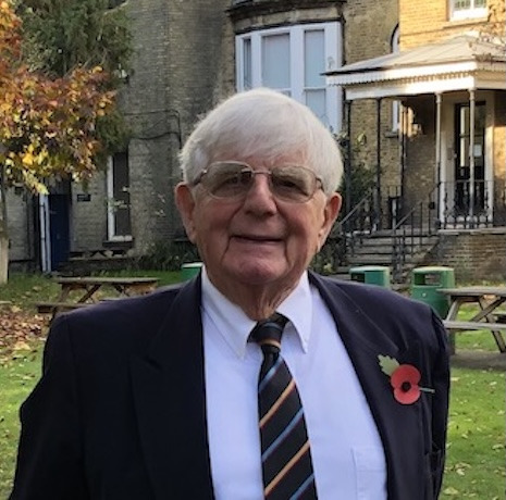 Prof. Julian V. Minghi standing in front of his secondary school, Clapham College, London