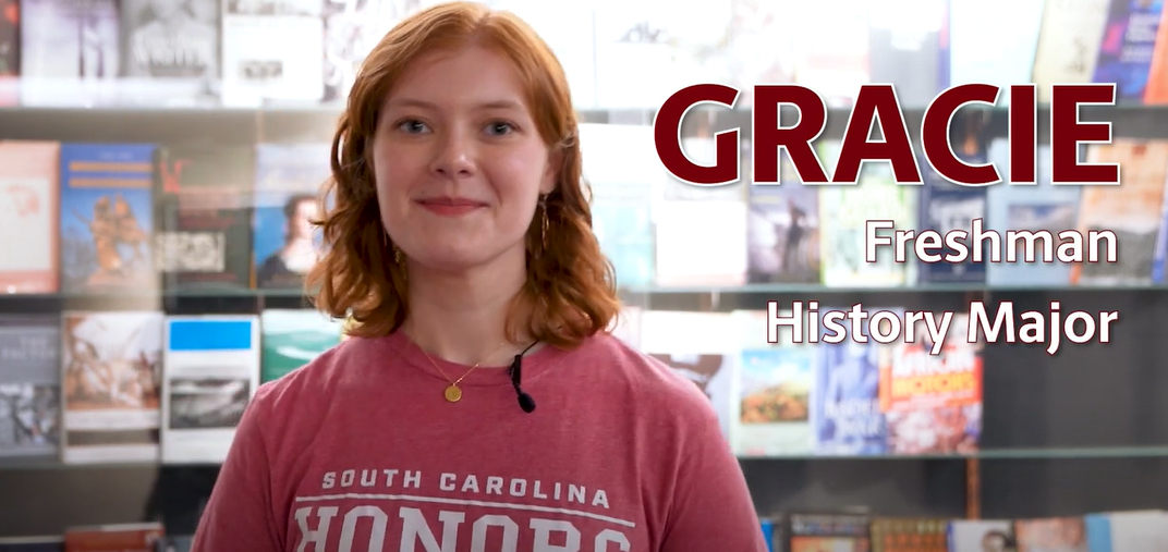 photo of student with red hair and honors tshirt on