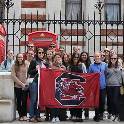 Students holding a UofSC flag in London