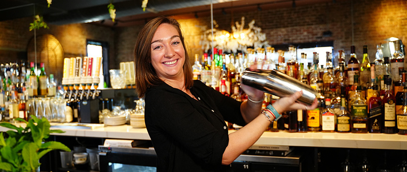 Jess Pomerantz shakes up a cocktail at her bartending job.
