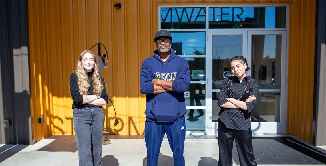 Ken Tips, Madeline Walshe, and Anthony Lewis stand outside of Stormwater Studio.